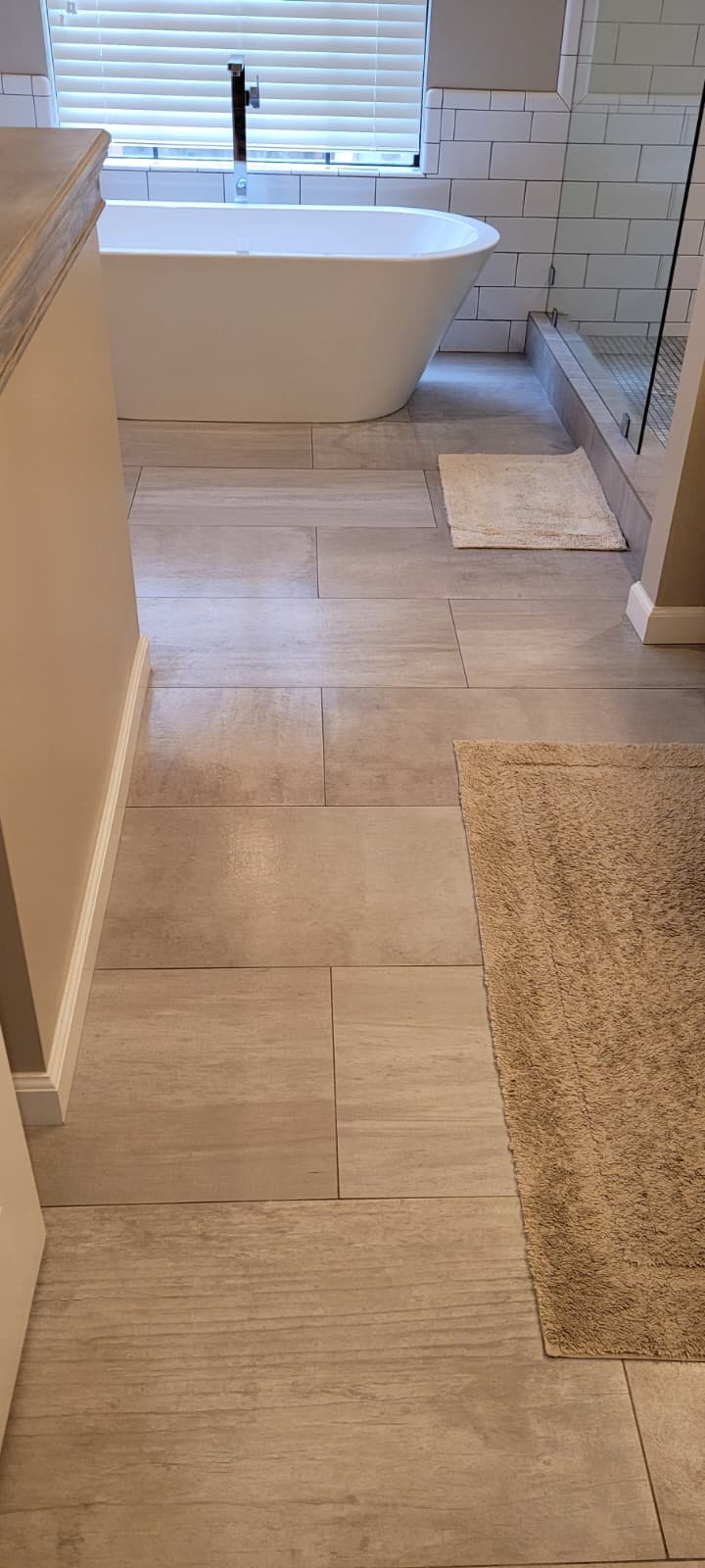 Clean light tile bathroom floor
