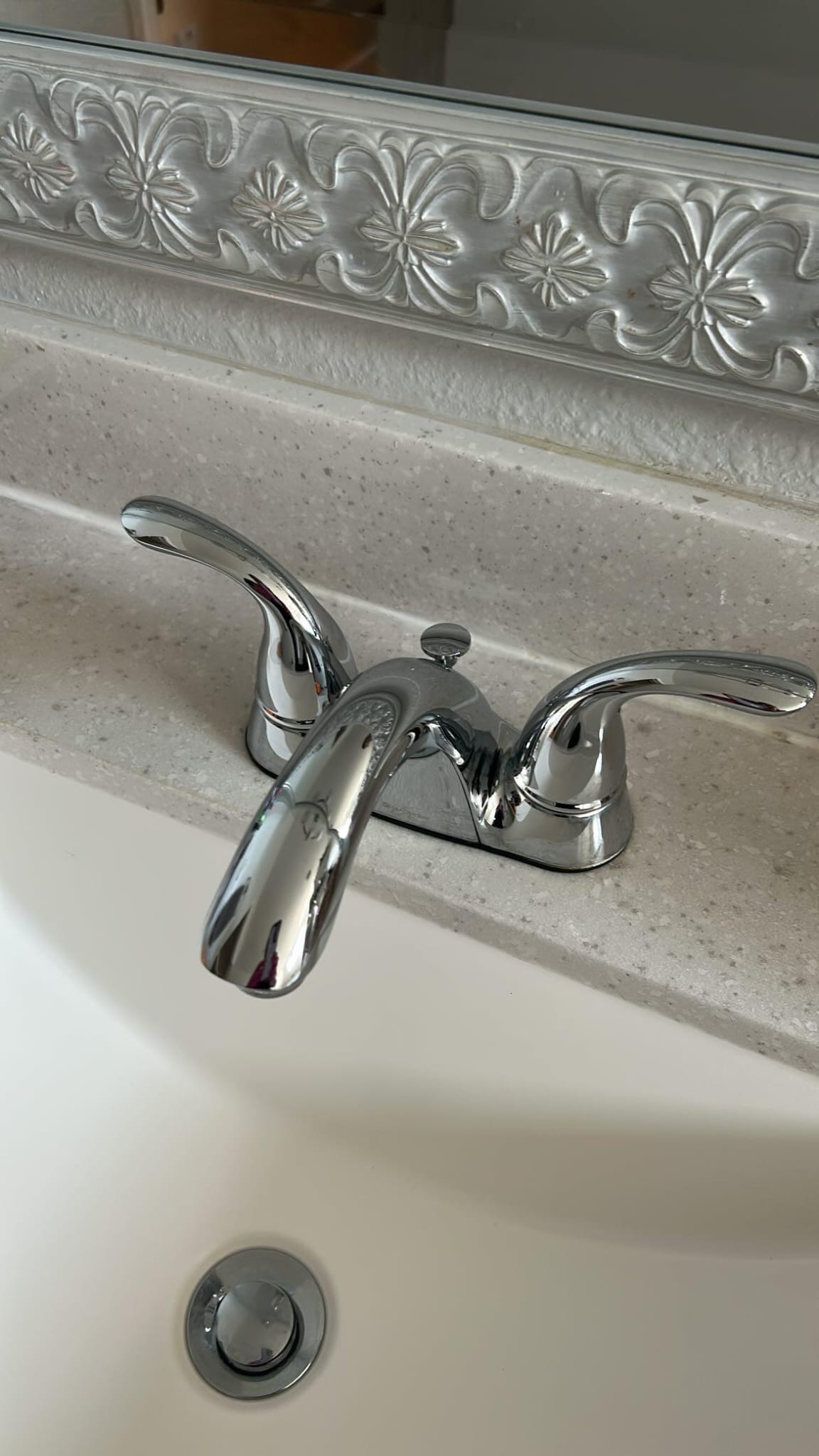 Detailed chrome vanity faucet on light countertop