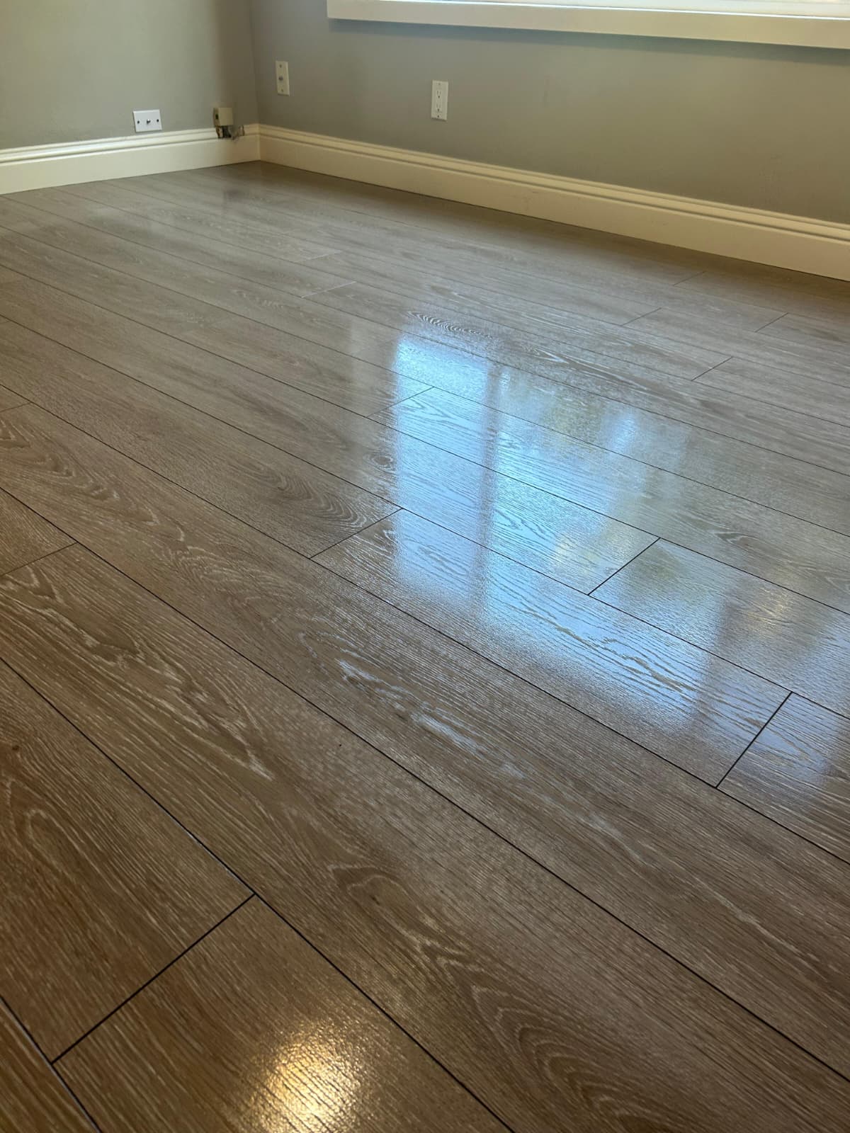 Gleaming light wood floor in an empty finished room