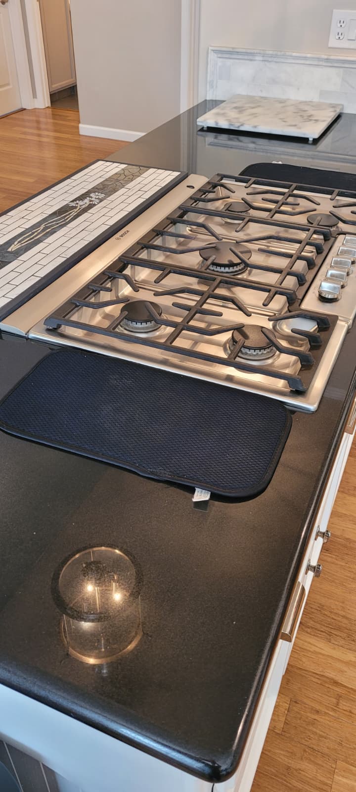 Polished cooktop and dark stone counter