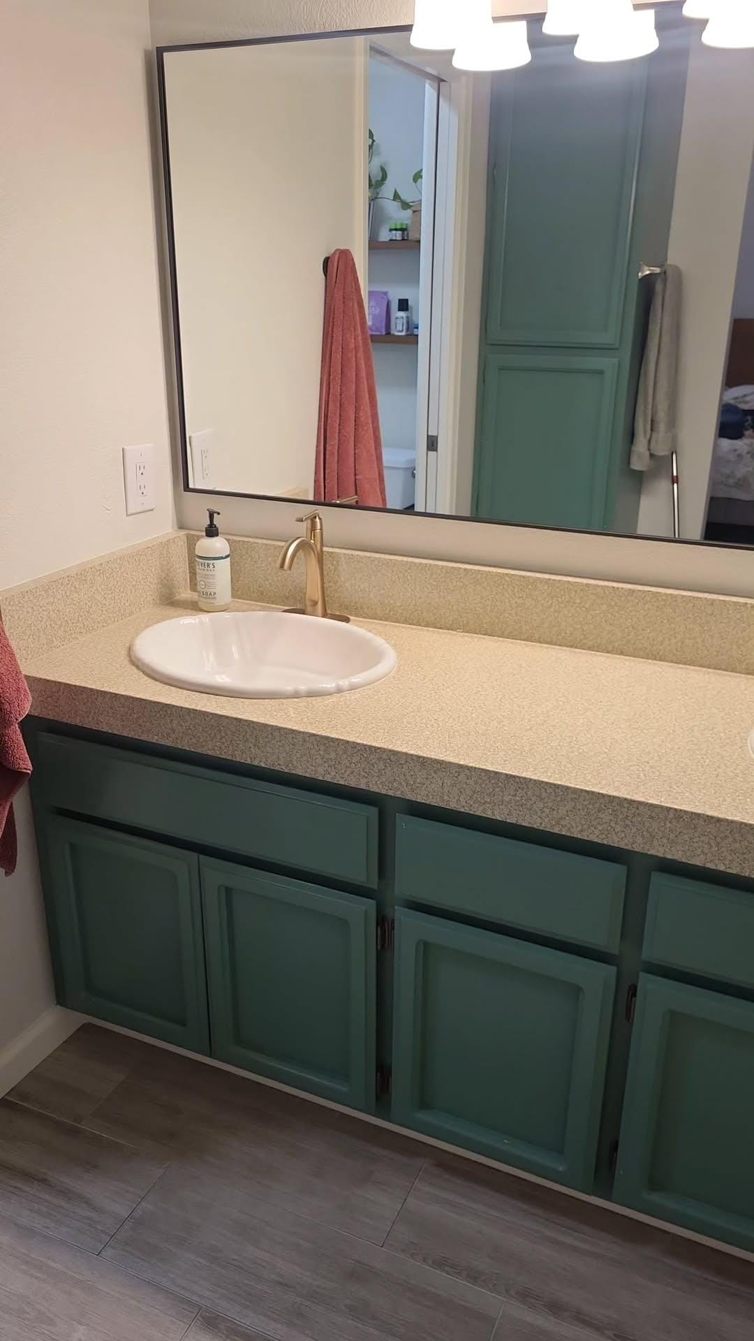 Refreshed guest bathroom with green vanity