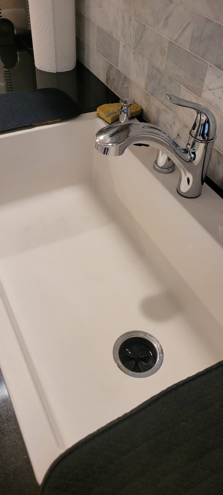 Spotless white bathroom sink and chrome faucet